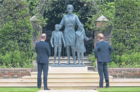  ??  ?? POIGNANT MOMENT: The Duke of Cambridge, left, and Duke of Sussex look at the newly-revealed statue of their mother Diana, Princess of Wales.