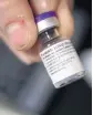 ?? BEN GARVER/AP ?? A pharmacist holds a bottle of the COVID-19 vaccine.