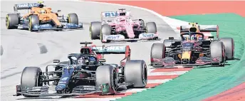  ?? — AFP photo ?? Mercedes’ driver Lewis Hamilton steers his car in front of Red Bull’s driver Alex Albon during the Austrian Formula One Grand Prix race in Spielberg, Austria.