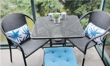  ??  ?? The condo’s small balcony is just right for a table and a spot for puppy Hilo to watch the world go by.