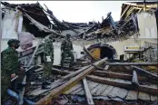  ?? THE ASSOCIATED PRESS ?? Soldiers inspect the remains of a building damaged in an earthquake in Petrinja, Croatia, Tuesday.