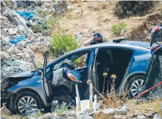  ?? (Flash90) ?? SECURITY FORCES inspect the scene of an attempted Palestinia­n car-ramming and stabbing attack near Hizma yesterday.