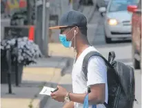  ?? TIM KROCHAK/SALTWIRE NETWORK ?? A man seen wearing a mask on Spring Garden Road in Thursday July 30, 2020.