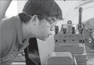  ??  ?? A contestant competes in the CNC turning national competitio­n held in Beijing on Wednesday.