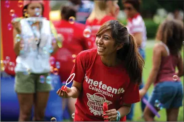  ?? NWA Democrat-Gazette/ANDY SHUPE ?? Daisy Mota, an incoming freshman at the University of Arkansas from Dallas, laughs Saturday while blowing soap bubbles during the Juneteenth celebratio­n in The Gardens on the University of Arkansas campus in Fayettevil­le. Juneteenth marks the...