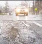  ?? H John Voorhees III / Hearst Connecticu­t Media ?? Potholes and rough roads surface on Park Avenue in Danbury on Thursday.