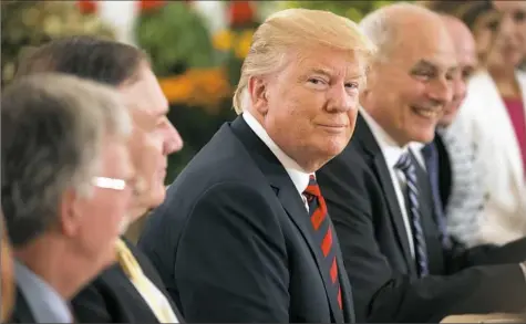  ?? Evan Vucci/Associated Press photos ?? President Donald Trump listens during a meeting with Singapore Prime Minister Lee Hsien Loong ahead of a summit with North Korean leader Kim Jong Un on Monday in Singapore.