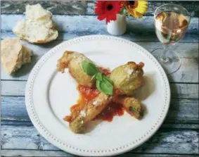  ?? SARA MOULTON VIA AP ?? Stuffed fried zucchini blossoms