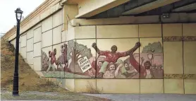  ?? ANGELA PETERSON/MILWAUKEE JOURNAL SENTINEL ?? RIGHT: The story of Joshua Glover, who fled Missouri in 1852 and sought freedom in Wisconsin, one of the most well-known fugitive slave incidents, is depicted on the walls of the I-43 overpass on Fond du Lac Avenue.