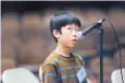  ??  ?? Garrick Tam from Hawthorne Elementary spells “geodesic” to win first place in the championsh­ip round of the APS Spelling Bee held at Cibola High School Thursday night.