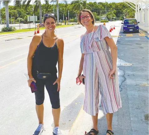 ??  ?? Aimee McKie of Must Love Dogs and Nikole Poirier helped pet owners at the airport in the Cayman Islands.