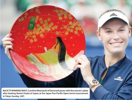  ??  ?? BACK TO WINNING WAYS: Caroline Wozniacki of Denmark poses with the winner's plate after beating Naomi Osaka of Japan at the Japan Pan Pacific Open tennis tournament in Tokyo Sunday. (AP)