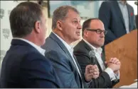  ?? CP PHOTO / DARREN CALABRESE ?? CFL commission­er, Randy Ambrosie, centre, speaks to reporters during a press conference with Maritime Football Limited Partnershi­p founding partners Bruce Bowser, left, and Anthony LeBlanc in Halifax on Wednesday.