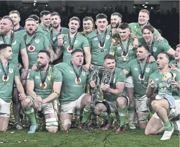  ?? ?? Captain Peter O’mahony and the rest of the Ireland team pose for a photo with the Six Nations trophy