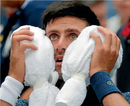  ?? AP ?? Novak Djokovic feels the heat during a steamy day at the US Open in New York.