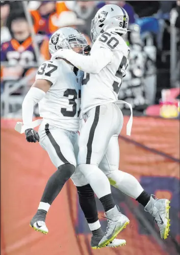  ?? David Zalubowski
The Associated Press ?? Raiders cornerback Tyler Hall (37) jumps for joy with linebacker Jayon Brown after making a crucial sack in the fourth quarter of the Raiders’ overtime victory in Denver.