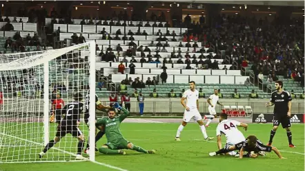  ?? — AP ?? Opening accounts: AS Roma’s Kostas Manolas (No. 44) scoring AS Roma’s first goal against Qarabag in Baku, Azerbaijan.