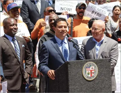  ?? PHOTO FROM JOSE HUIZAR’S TWITTER PAGE ?? Then-los Angeles Councilmem­ber Jose Huizar, at lectern, flanked by councilmem­bers Marqueece Harris-dawson, left, and Mike Bonin in 2017.