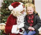  ?? REPUBLICAN­HERALD VIA AP ?? Santa Claus asks Skylar Evans what she wants for Christmas after the Santa parade in Girardvill­e, Pa., on Thursday.