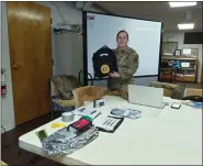  ?? MELISSA SCHUMAN — MEDIANEWS GROUP ?? Master Sergeant Lydia Gerardi holds up an example emergency go bag, with examples of what it should hold on