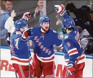  ?? Frank Franklin II / Associated Press ?? New York Rangers’ Alexis Lafreniere (13) celebrates with teammates Filip Chytil (72) and Jacob Trouba (8) after scoring a goal during the second period of Game 5 of an NHL hockey Stanley Cup first-round playoff series against the Pittsburgh Penguins on Wednesday in New York.