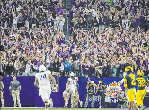  ?? Ross D. Franklin The Associated ?? Texas Christian receiver Quentin Johnston runs for a touchdown Saturday during the Horned Frogs’ 51-45 victory over Michigan.