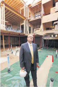  ?? ARCHIVES PHOTO] [OKLAHOMAN ?? Contractor Stan Lingo, of Lingo Constructi­on, surveys progress while restoring the Marion Hotel. It was built in 1908 at NW 10 and Broadway. The building is now apartments.