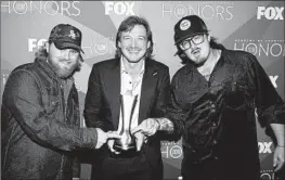  ?? Terry Wyatt Getty Images for ACM ?? ERNEST, left, with Morgan Wallen and Hardy at the Academy of Country Music Honors in 2022. The trio co-wrote songs for Wallen’s hit album “Dangerous.”