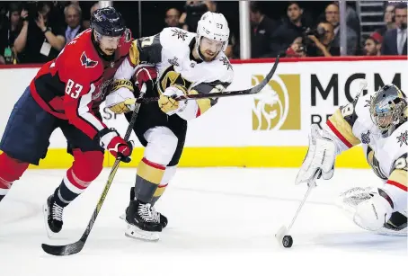  ?? ALEX BRANDON/THE ASSOCIATED PRESS ?? Washington Capitals forward Jay Beagle, left, is all over Vegas Golden Knights defenceman Shea Theodore as he tries to move the puck during Game 3 action in the Stanley Cup final. The Caps ‘team-defence’ mantra has stifled the Vegas offence in the...