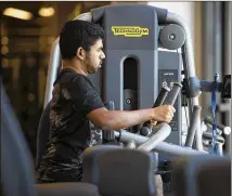  ??  ?? Lokesh Ravichandr­an, an associate senior software engineer, works out during lunch April 27 on Cerner’s Innovation­s Campus. He says the workout re-energizes him and allows him to focus on his work.