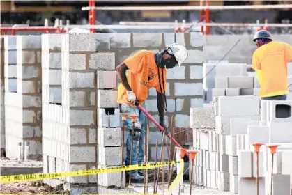  ?? RICARDO RAMIREZ BUXEDA/ORLANDO SENTINEL ?? Workers build Hawthorne Park, a senior affordable housing community in Pine Hills, on Wednesday.