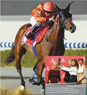  ?? Virendra Saklani/Gulf News ?? Michelle Perry, Manager Sales, Emirates Holidays presenting trophy to connection­s of Walking Thunder. Walking Thunder, ridden by Connor Beasley and trained by Ahmad Bin Harmash, wins the Emirates Holidays Maiden, the first race of the 2018-19 season at Meydan yesterday.