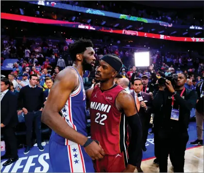  ?? MATT SLOCUM — THE ASSOCIATED PRESS ?? Joel Embiid, left, embraces Miami’s Jimmy Butler after the 76ers exited the playoffs following Game 6of the Eastern Conference semifinal Thursday.