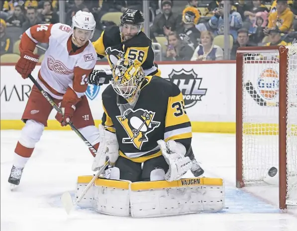  ??  ?? Tristan Jarry makes one of his 29 saves in a 4-1 Penguins win Saturday at PPG Paints Arena.