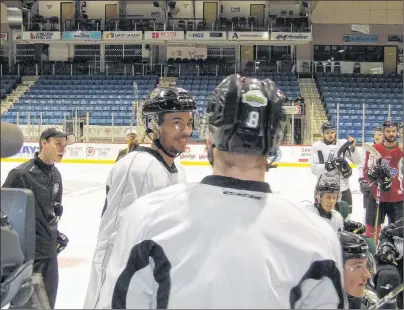  ?? CHARLES REID/THE GUARDIAN ?? Charlottet­own Islanders defenceman and captain Pierre-Olivier Joseph left, smiles as he explains a drill to defensive partner Saku Vesterinen at Isles practice Monday in Charlottet­own. The Isles host the Blainville-Boisbriand Armada on Tuesday in Game...