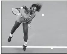  ?? AP PHOTO ?? Serena Williams serves to Romania’s Simona Halep during their fourth round match at the Australian Open tennis championsh­ips in Melbourne, Australia on Jan. 21.