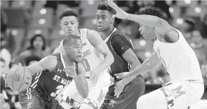  ?? PATRICK SEMANSKY/ASSOCIATED PRESS ?? St. Mary’s guard Donovan Robinson drives against Maryland guard Anthony Cowan, second from left, Seahawks forward Marsalis Hurley and Terps forward L.G. Gill, right, in the second half. Gill led Maryland with 15 points off the bench.