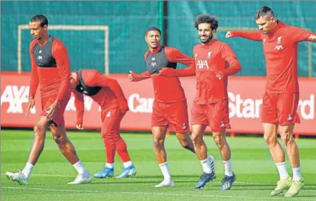  ?? AFP ?? ■ Liverpool players take part in a training session at their Melwood complex, Liverpool, on the eve of their Champions League group stage match against Napoli.
