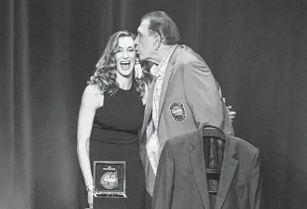  ?? Kathy Willens / Associated Press ?? Rudy Tomjanovic­h kisses one of his daughters at the Basketball Hall of Fame awards tip-off celebratio­n Friday in Uncasville, Conn.