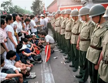  ??  ?? A 30-YEAR FIGHT Below: Pro-democracy demonstrat­ors stand their ground outside Communist Party headquarte­rs in Beijing, days before the 1989 Tiananmen Square massacre. Right: Commemorat­ing the event’s 30th anniversar­y in Hong Kong’s Victoria Park.