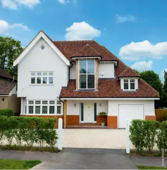  ??  ?? Above: This threestore­y self build home features a wow factor large window at the front, which fills the entrance hallway and staircase with natural light