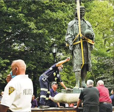  ?? Peter Hvizdak / Hearst Connecticu­t Media ?? The statue of Christophe­r Columbus was removed from Wooster Square park on Wednesday after a skirmish erupted early in the morning between people of opposing viewpoints. Later, with a large police presence, hundreds of people gathered to watch the removal of the monument and demonstrat­e against racism.