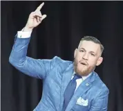  ?? TOM SZCZERBOWS­KI, USA TODAY SPORTS ?? Conor McGregor looks dapper in his designer suit even as he hurls insults at Floyd Mayweather Jr.