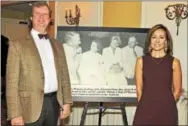  ??  ?? Jim and Betsy Kane stand in front of a Parents Picture from 1992.