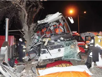  ??  ?? Rescue workers attend around a bus, carrying mostly holiday-makers on a skiing trip, after it crashed into trees on the side of a road, in Eskisehir, on Saturday. (AP)