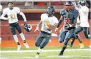  ?? BRYAN TERRY, THE OKLAHOMAN] [PHOTO BY ?? Midwest City’s Oshei Whiteside runs to the end zone for a touchdown after catching the ball in front of Del City’s Jamaree Ayers during Thursday’s game in Del City.