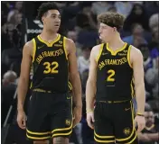  ?? JEFF CHIU — THE ASSOCIATED PRESS ?? Rookies Trayce Jackson-Davis (32) and Brandin Podziemski (2) have played key roles for the Warriors this season.