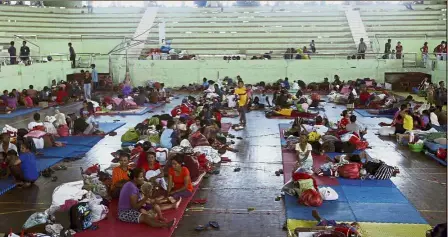  ??  ?? Fleeing to safety: Villagers resting at a temporary shelter in Klungkung, Bali. — AP