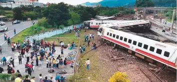  ?? AFP ?? A derailed train in Yian, eastern Taiwan. All of the train’s eight carriages derailed and five had flipped onto their side at Xinma station.