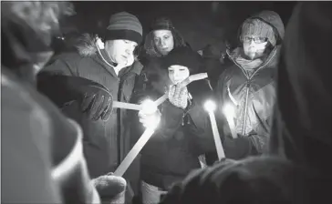  ?? Gavin Young/calgary Herald ?? About 150 friends of Brandon Thomas gathered for a candleligh­t vigil Saturday night in Cochrane to remember the 17-year-old student and raise money to help out Brandon’s single mom, Kim, who spoke at the event.